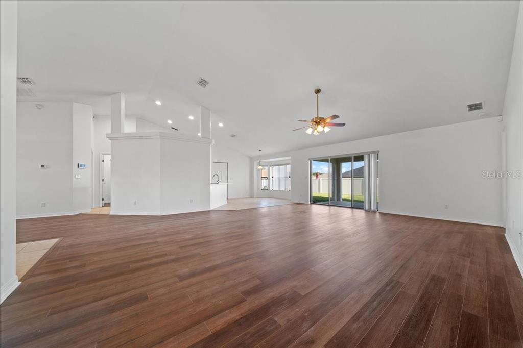 5659 Southwest 89th Place Ocala, FL 34476 - Photo 11 of 76 a view of an empty room with wooden floor and a window