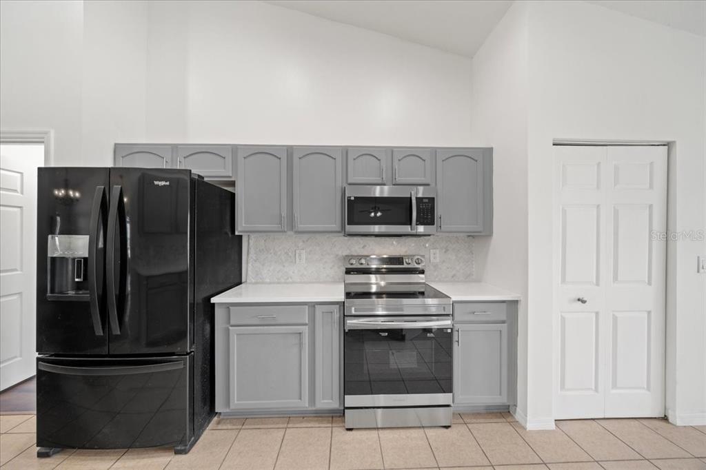 5659 Southwest 89th Place Ocala, FL 34476 - Photo 18 of 76 a kitchen with stainless steel appliances granite countertop a refrigerator stove and microwave