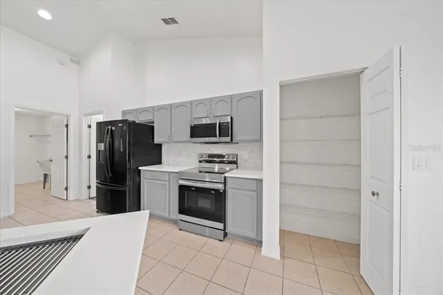 a bathroom with a double vanity sink a mirror and a bathtub