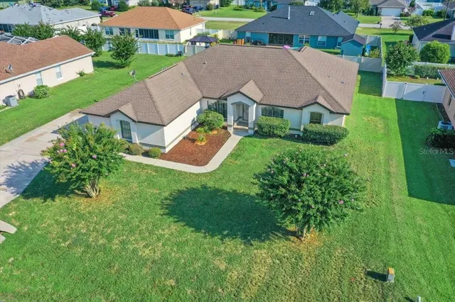an aerial view of a house with swimming pool garden and outdoor seating