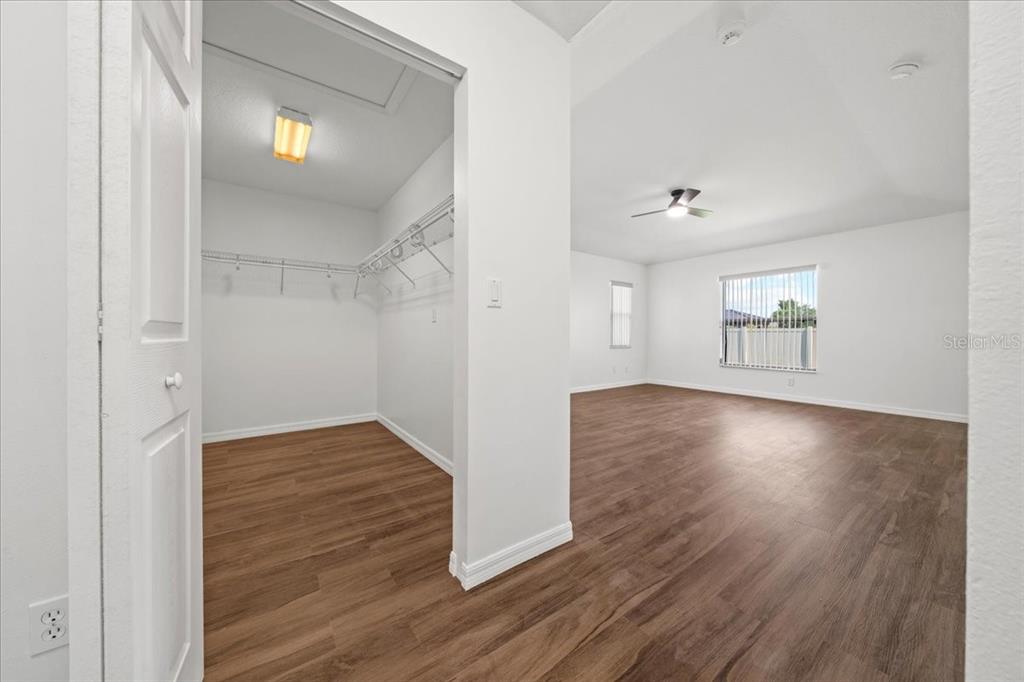 5659 Southwest 89th Place Ocala, FL 34476 - Photo 22 of 76 an empty room with wooden floor and windows