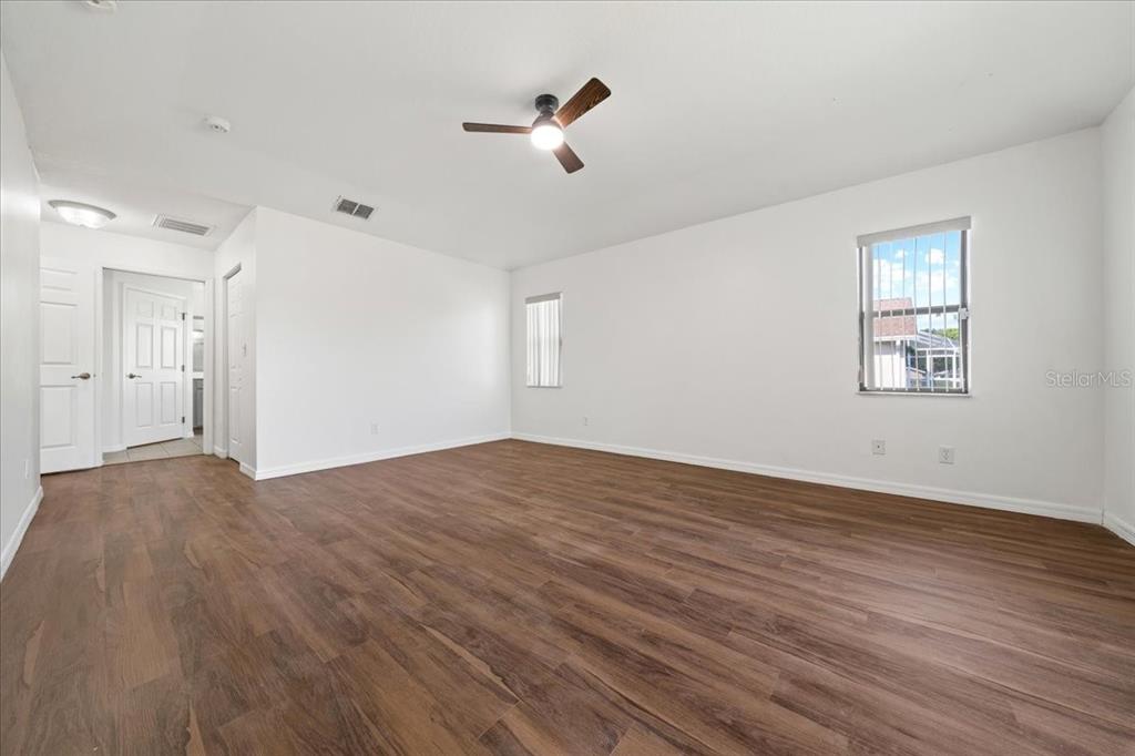 5659 Southwest 89th Place Ocala, FL 34476 - Photo 26 of 76 a view of empty room with wooden floor and fan