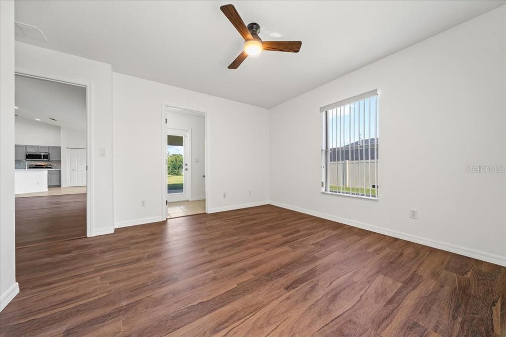 5659 Southwest 89th Place Ocala, FL 34476 - Photo 34 of 76 wooden floor in an empty room with a window
