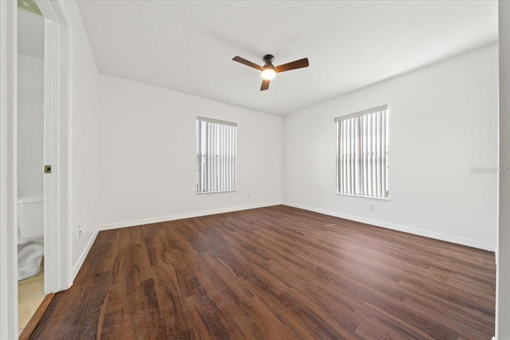 5659 Southwest 89th Place Ocala, FL 34476 - Photo 36 of 76 an empty room with wooden floor and windows