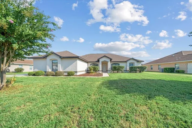 a front view of house with yard and trees