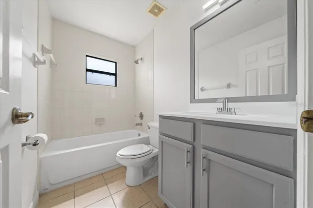 an aerial view of residential houses with outdoor space and trees all around