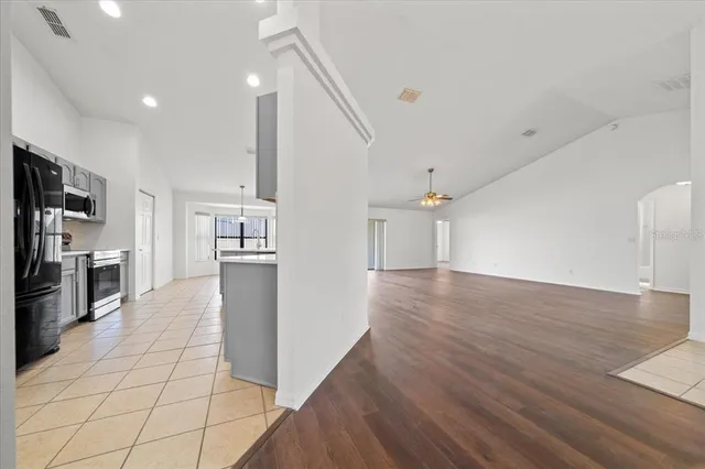 an aerial view of residential houses with outdoor space and trees