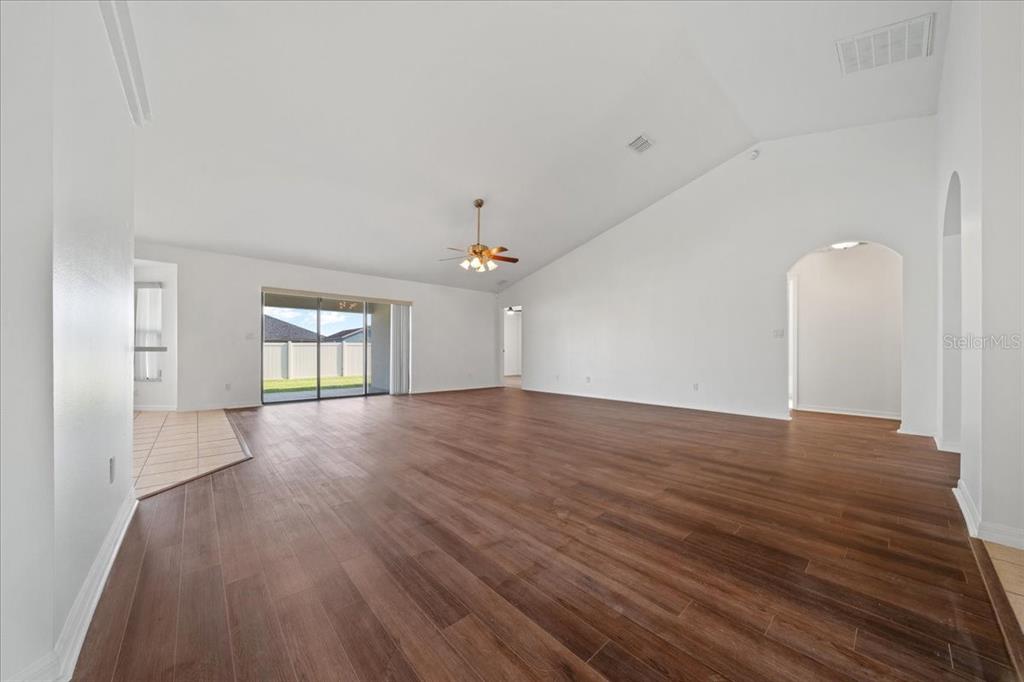 5659 Southwest 89th Place Ocala, FL 34476 - Photo 10 of 76 a view of an empty room with window and wooden floor