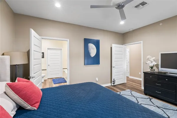 a bedroom with furniture and a flat screen tv