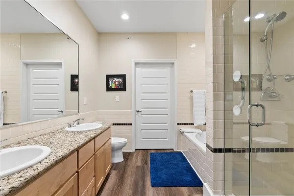 a bathroom with a granite countertop sink toilet and shower