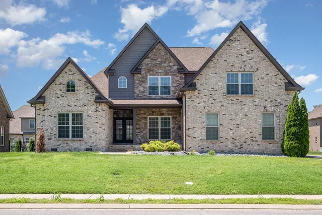 a front view of a house with a garden