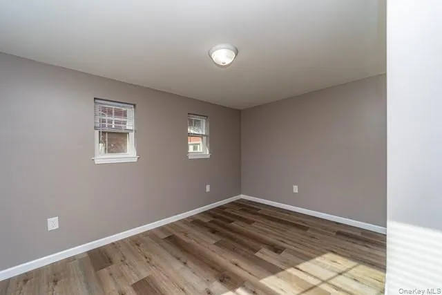 a view of a room with wooden floor and window