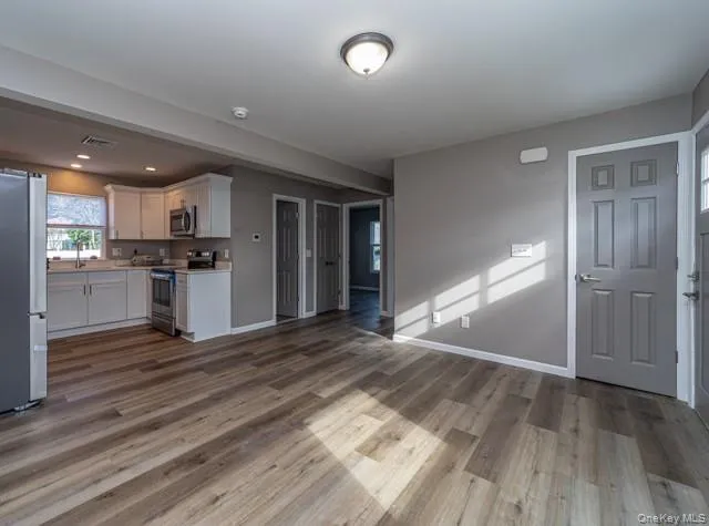 a view of a kitchen with a sink and a stove top oven