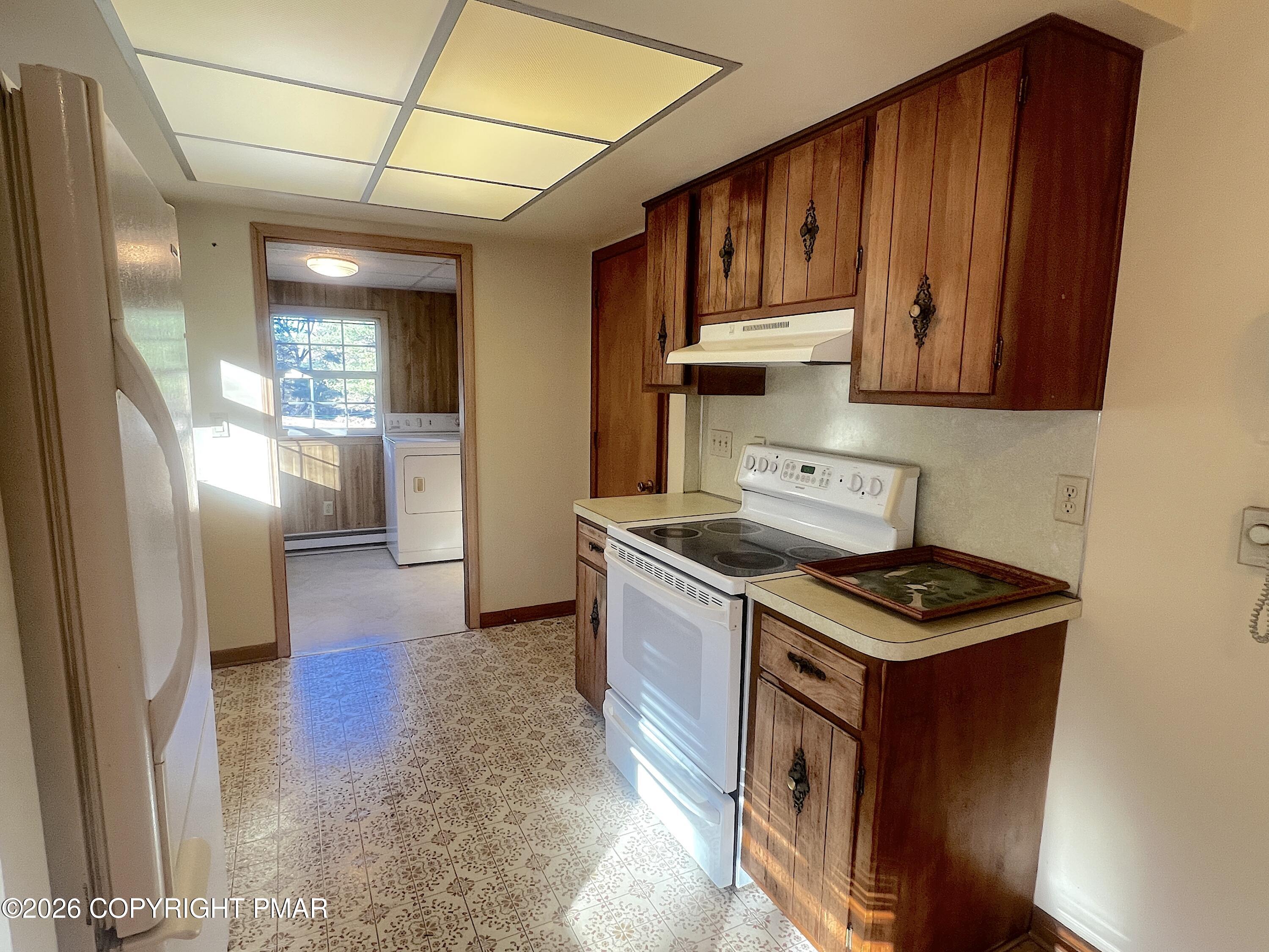 617 School Road Nazareth, PA 18064 - Photo 14 of 30 a kitchen with stainless steel appliances granite countertop a stove a refrigerator a sink dishwasher and wooden cabinets with wooden floor