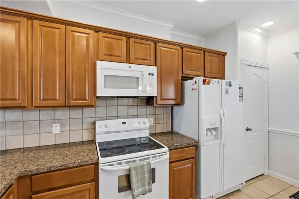 a kitchen with a stove and a refrigerator
