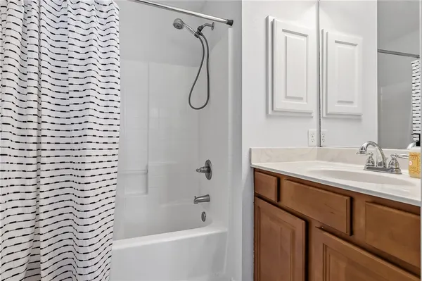 a bathroom with a granite countertop sink a toilet and shower