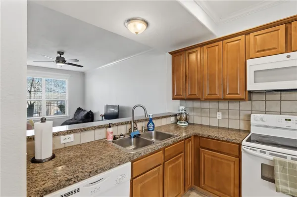 a kitchen with stainless steel appliances granite countertop a sink stove and cabinets