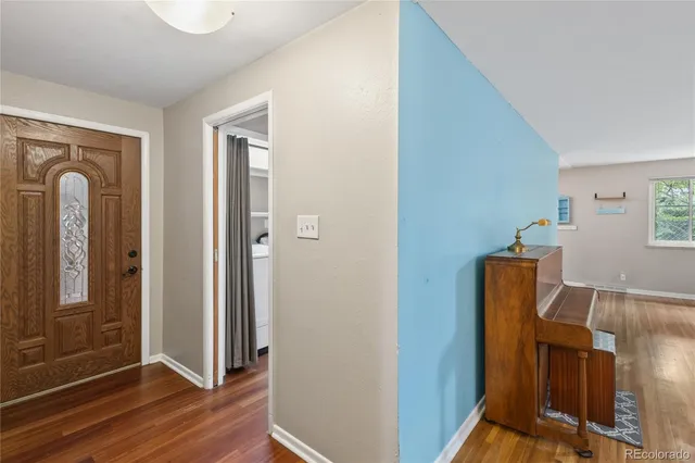 a view of a room with wooden floor and bathroom