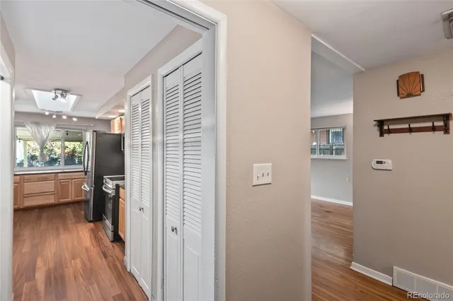 a view of a hallway with wooden floor and staircase