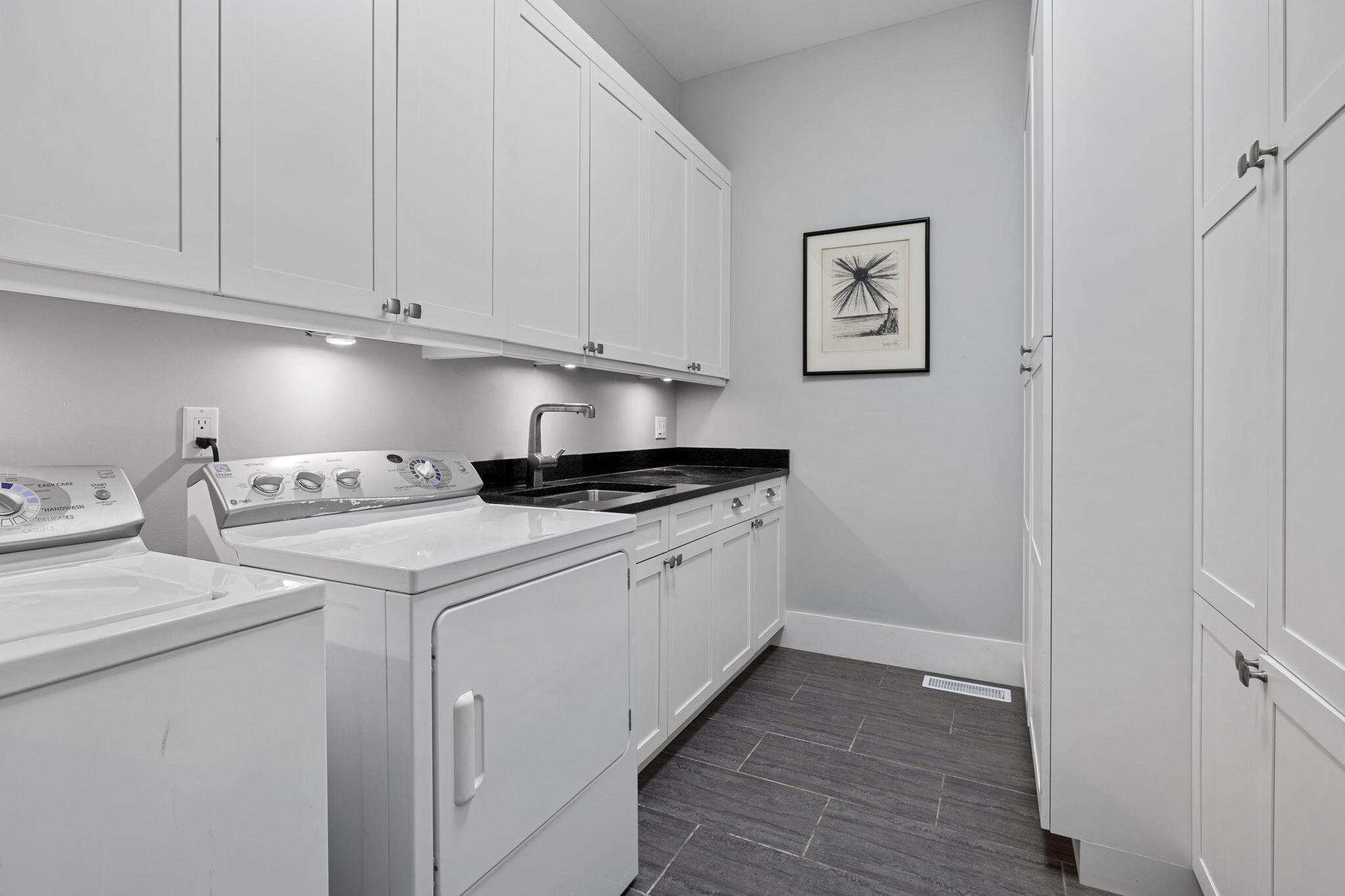 17138 River Bluff Drive, Unit 96 Union Pier, MI 49129 - Photo 49 of 89 a utility room with cabinets washer and dryer