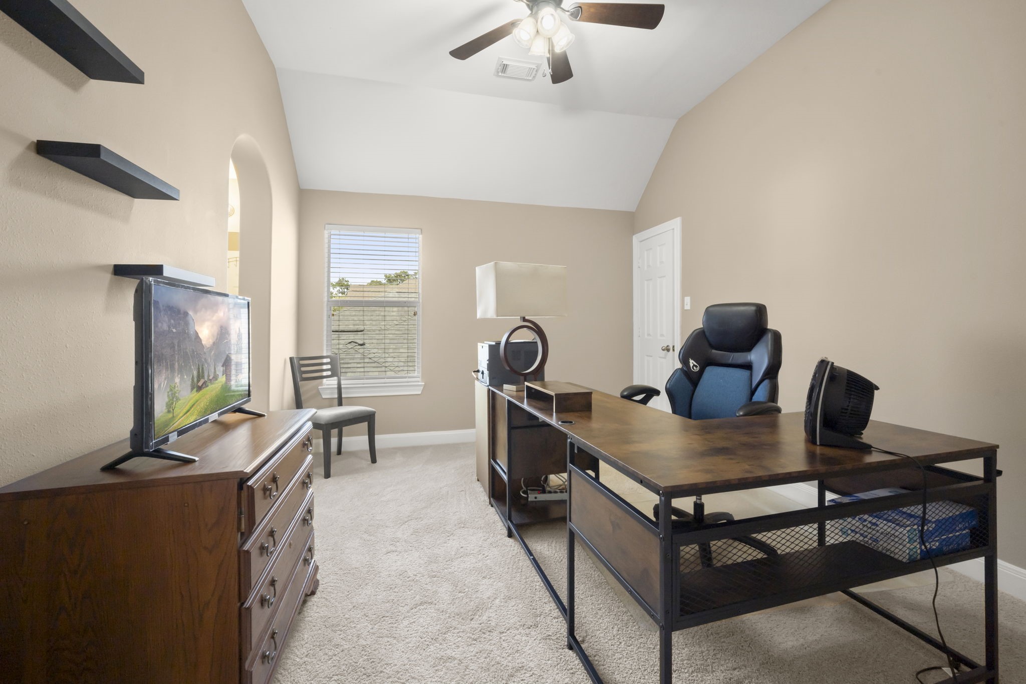 6315 Amelia Springs Drive Spring, TX 77379 - Photo 22 of 46 3rd Bedroom is well lite with neutral-toned walls, featuring a ceiling fan. plush carpet. There's a window letting in natural light.
