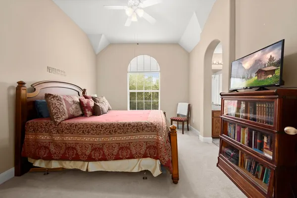 a view of a dining room with furniture and a chandelier fan