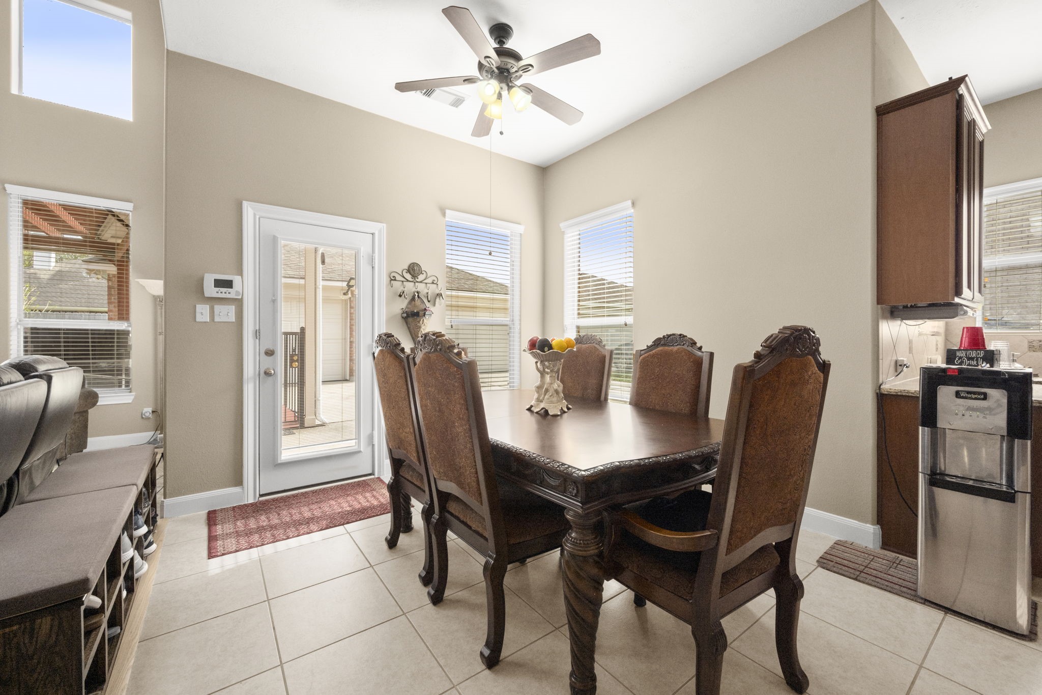 6315 Amelia Springs Drive Spring, TX 77379 - Photo 36 of 46 With the dining area it features natural light from multiple windows. It has tiled floors, neutral walls, and a ceiling fan, creating a cozy and inviting space. A door leads to an outdoor area, and there's easy access to the kitchen.
