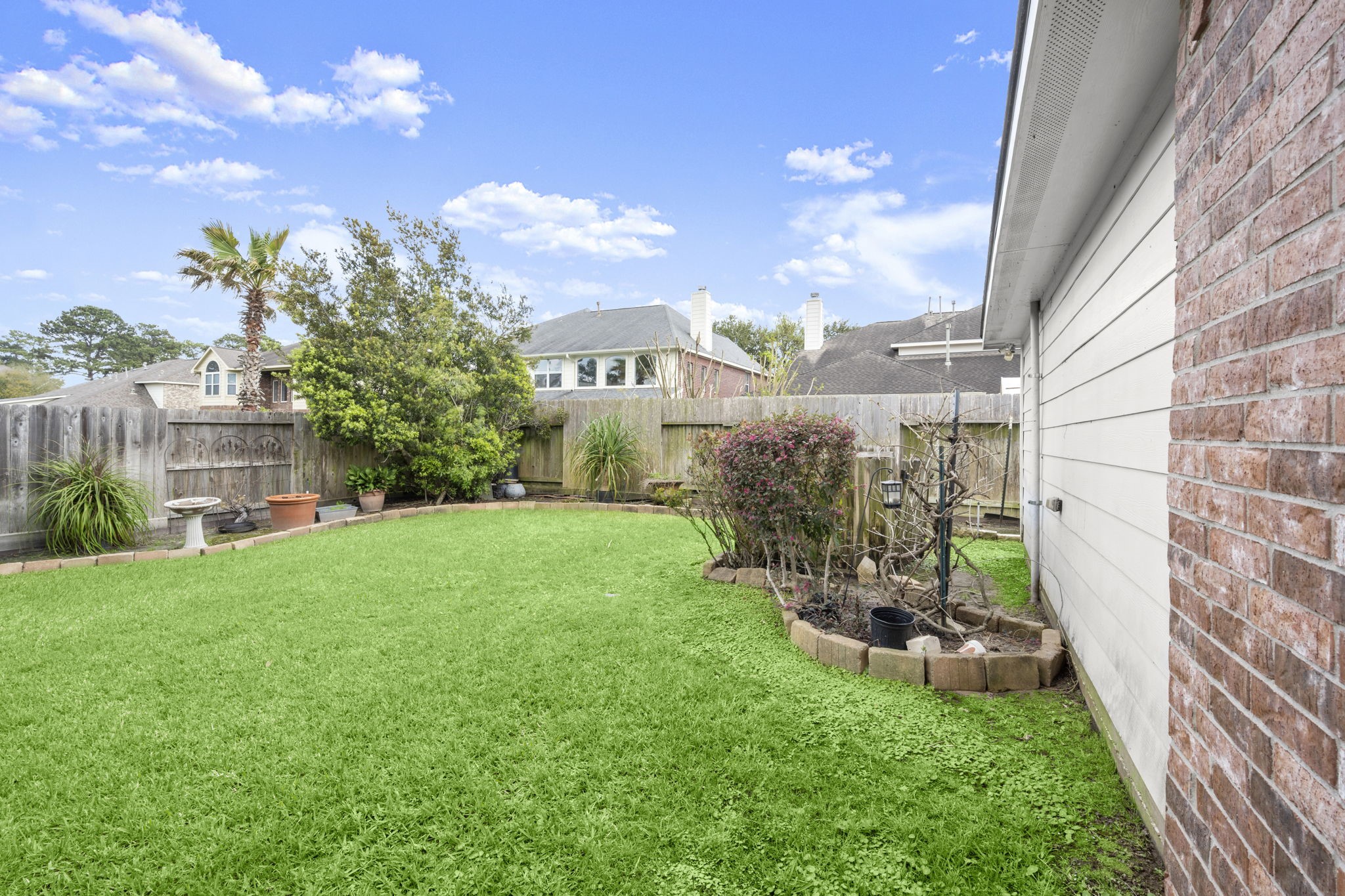 6315 Amelia Springs Drive Spring, TX 77379 - Photo 43 of 46 a view of a garden with a building in the background