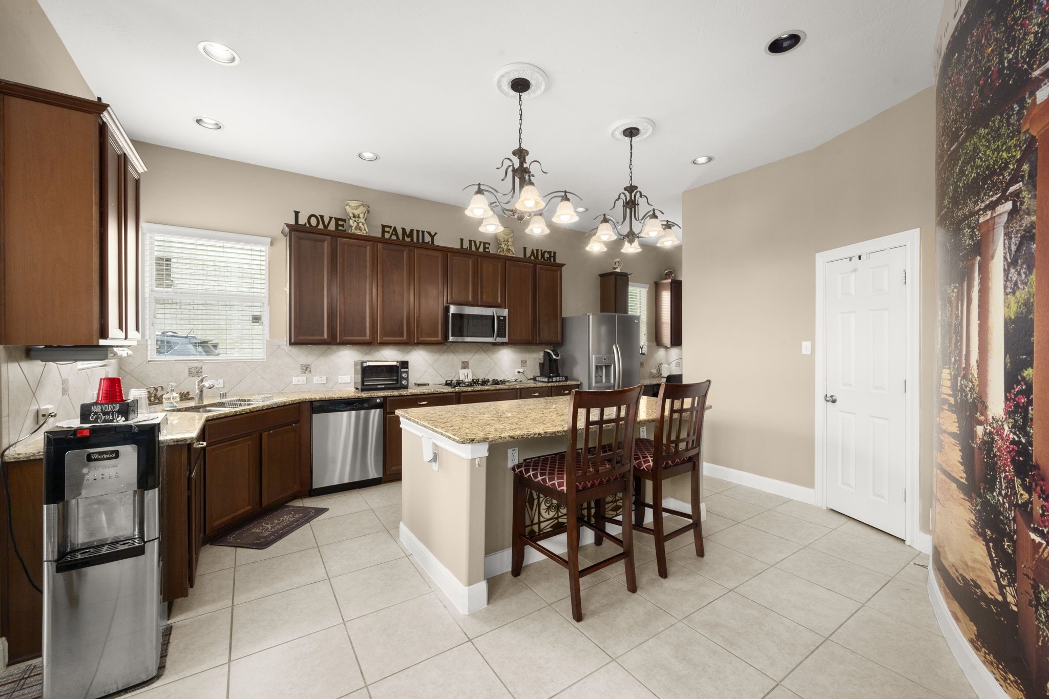 6315 Amelia Springs Drive Spring, TX 77379 - Photo 5 of 46 a kitchen with kitchen island granite countertop a sink counter top space appliances and cabinets