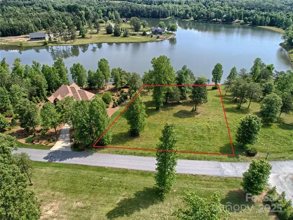 an aerial view of a houses with a lake view