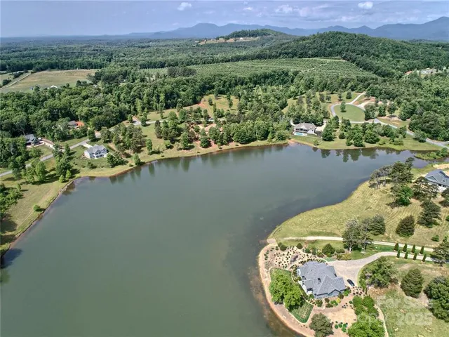 an aerial view of a house with a lake view