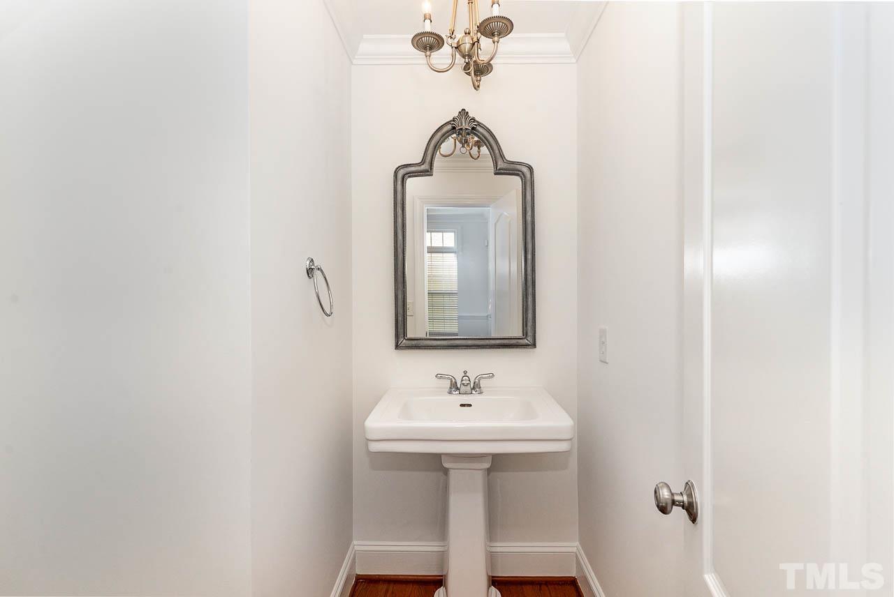 1217 Harp Street Raleigh, NC 27604 - Photo 11 of 27 a bathroom with a sink a mirror and shower
