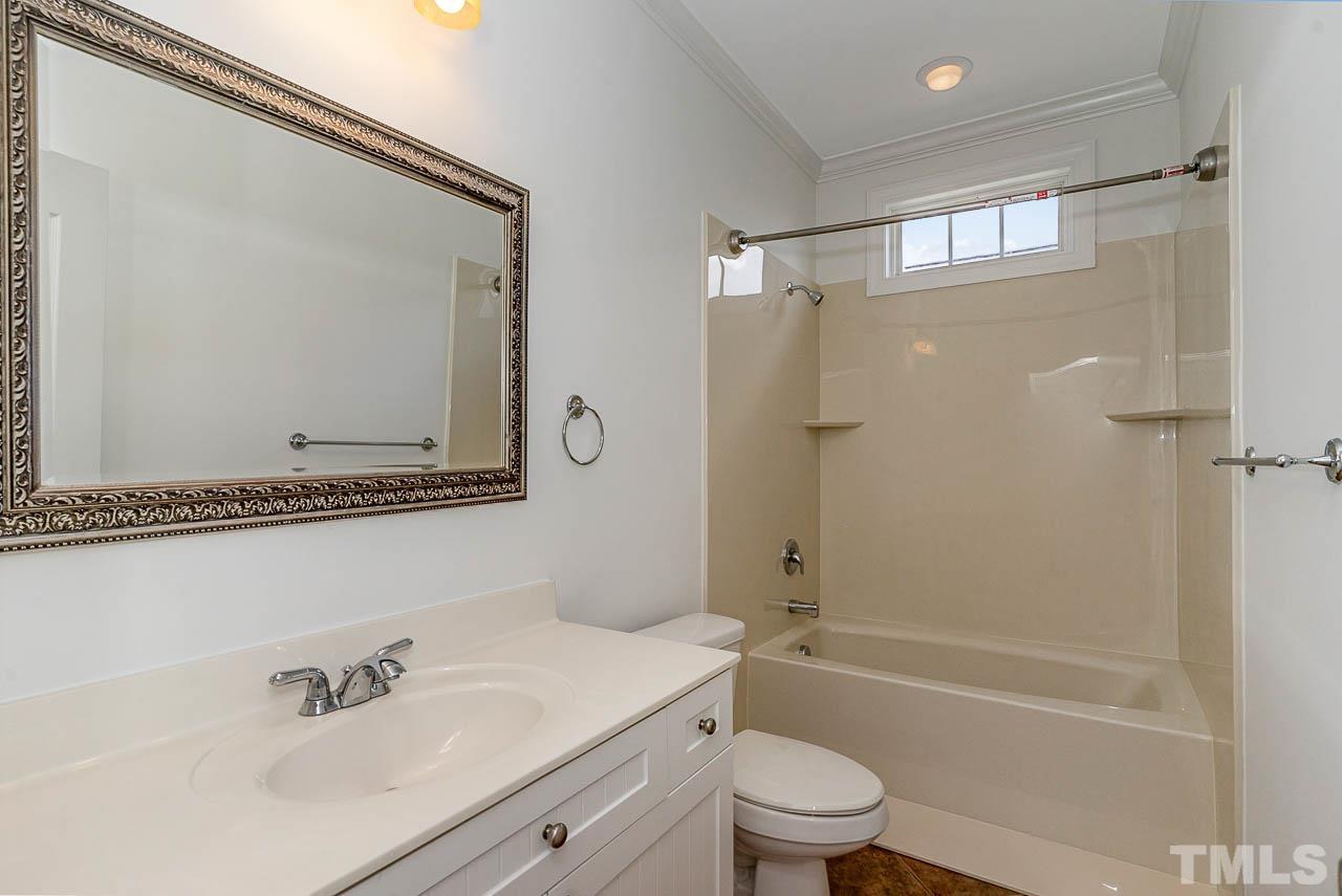 1217 Harp Street Raleigh, NC 27604 - Photo 17 of 27 a bathroom with a sink a toilet and a bathtub