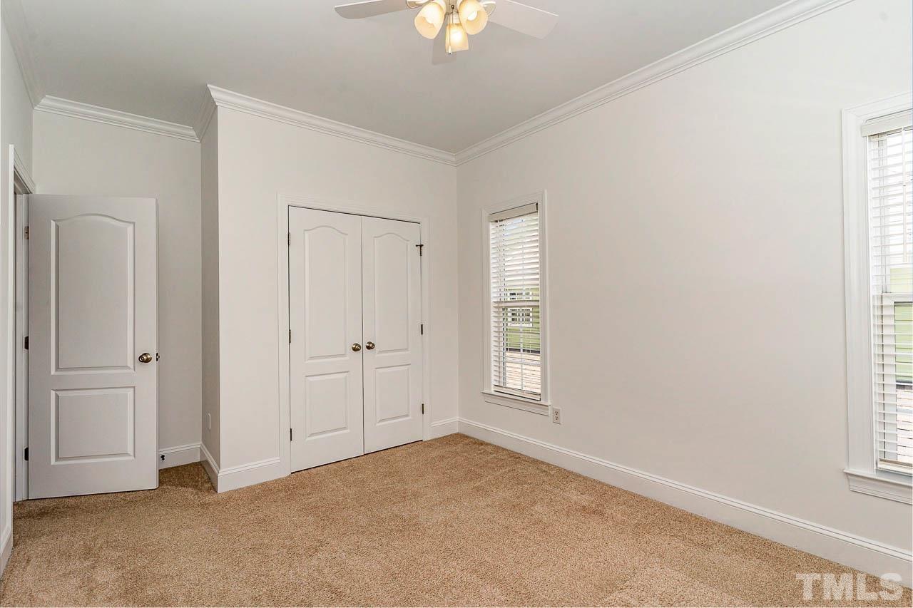 1217 Harp Street Raleigh, NC 27604 - Photo 18 of 27 an empty room with windows and chandelier fan