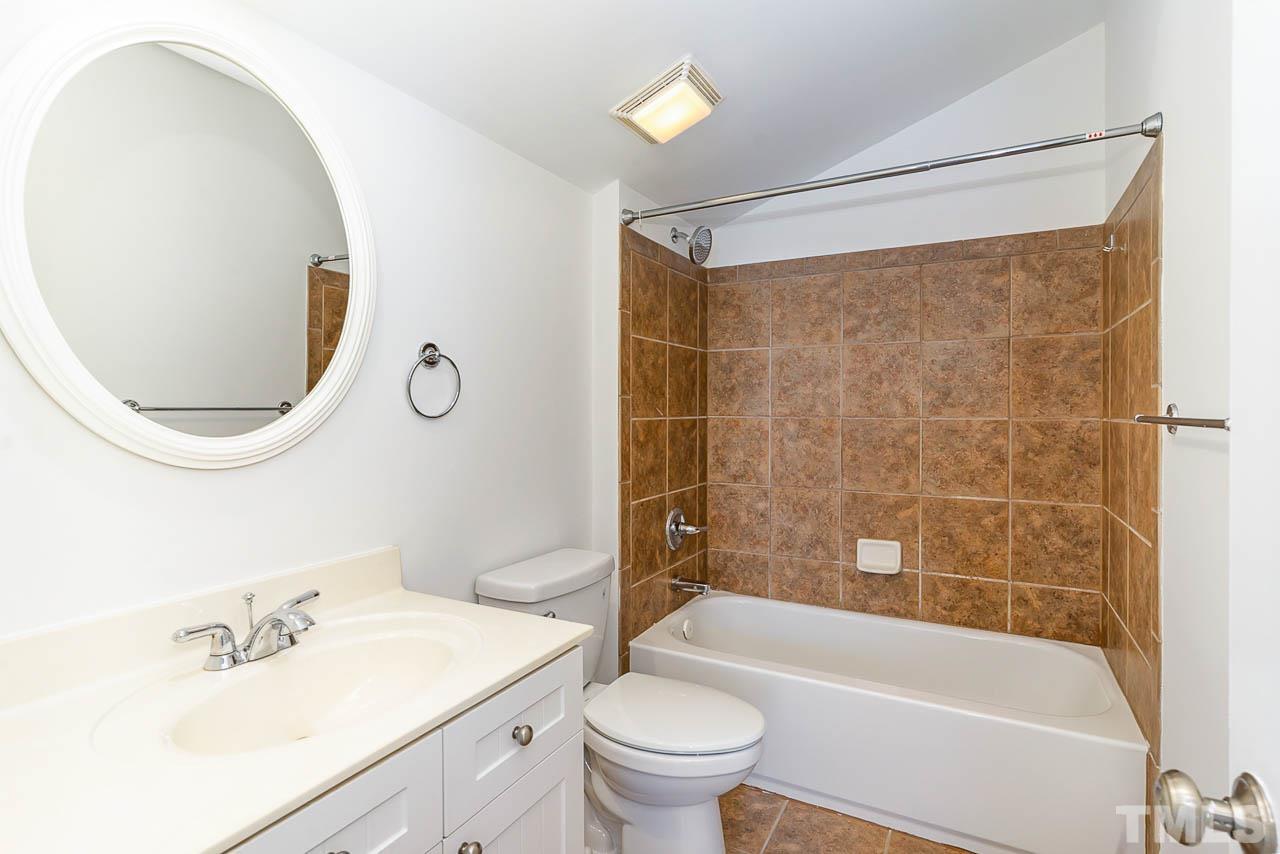 1217 Harp Street Raleigh, NC 27604 - Photo 26 of 27 a bathroom with a sink mirror toilet and bathtub