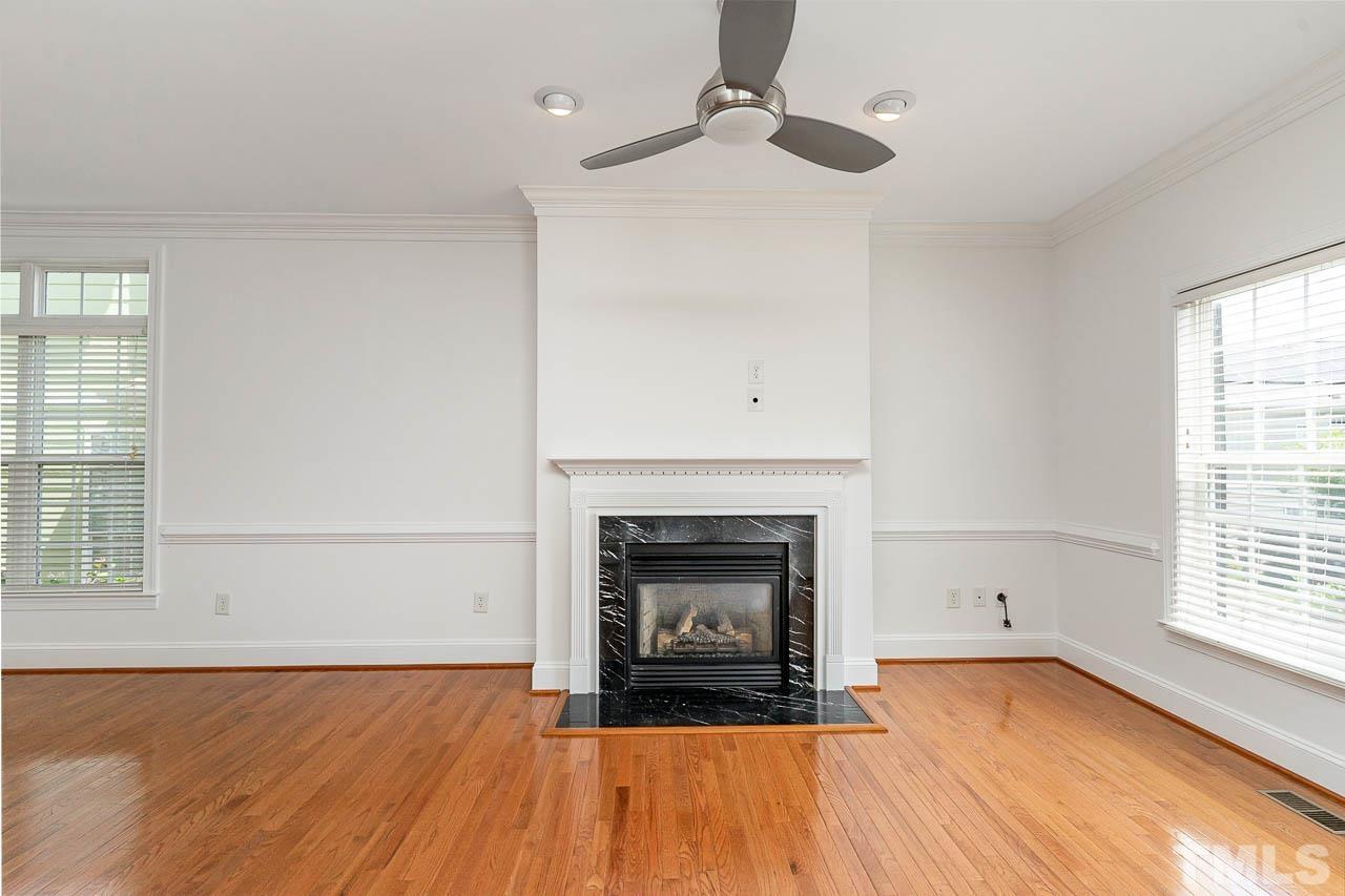 1217 Harp Street Raleigh, NC 27604 - Photo 3 of 27 an empty room with windows and fireplace