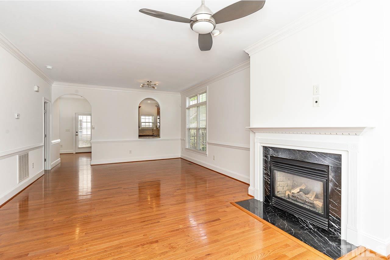1217 Harp Street Raleigh, NC 27604 - Photo 4 of 27 an empty room with windows and fireplace