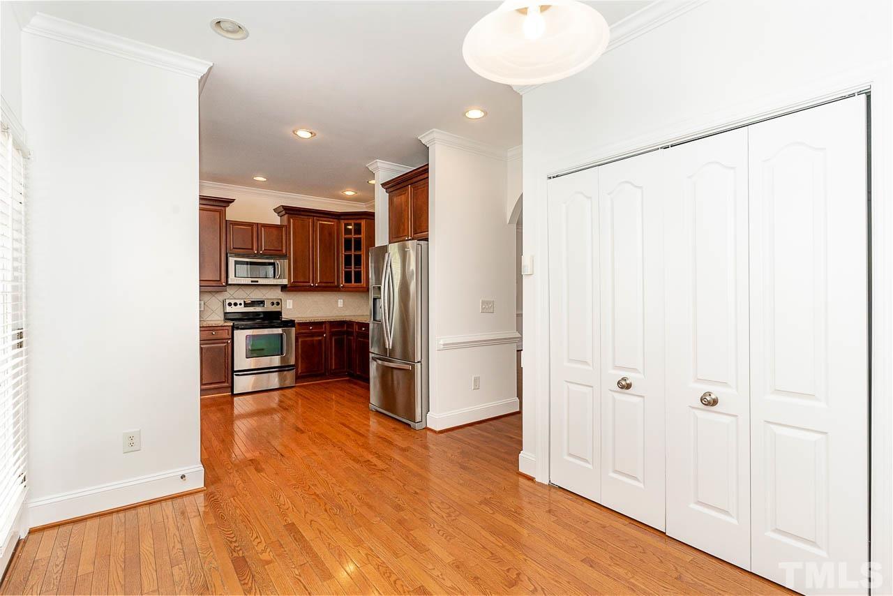 1217 Harp Street Raleigh, NC 27604 - Photo 7 of 27 a kitchen with stainless steel appliances a refrigerator and a stove top oven