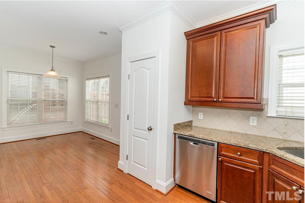 1217 Harp Street Raleigh, NC 27604 - Photo 10 of 27 a view of a kitchen with granite countertop cabinets and wooden floor
