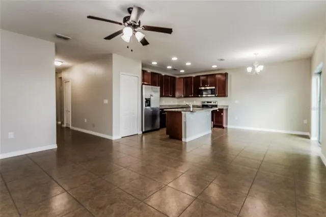 a view of a kitchen with a sink stainless steel appliances and cabinets