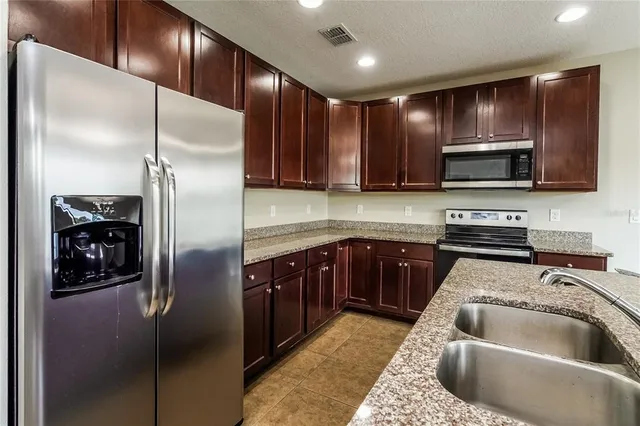 a kitchen with a refrigerator sink and microwave