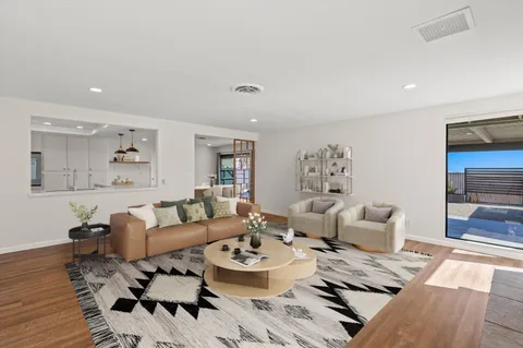 a living room with furniture and wooden floor