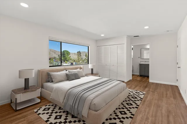 a bedroom with a large bed and a walk in closet