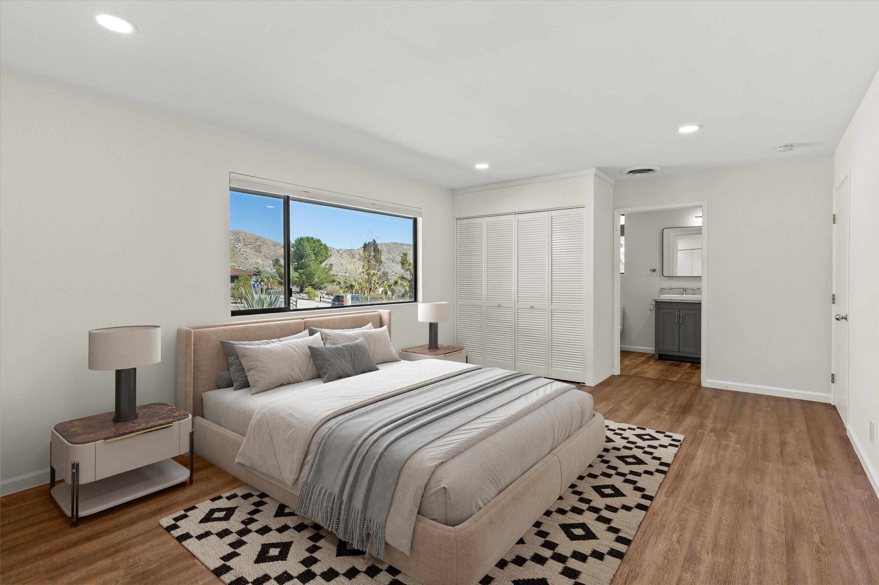 7458 Cardillo Trail Yucca Valley, CA 92284 - Photo 20 of 47 a bedroom with a large bed and a walk in closet