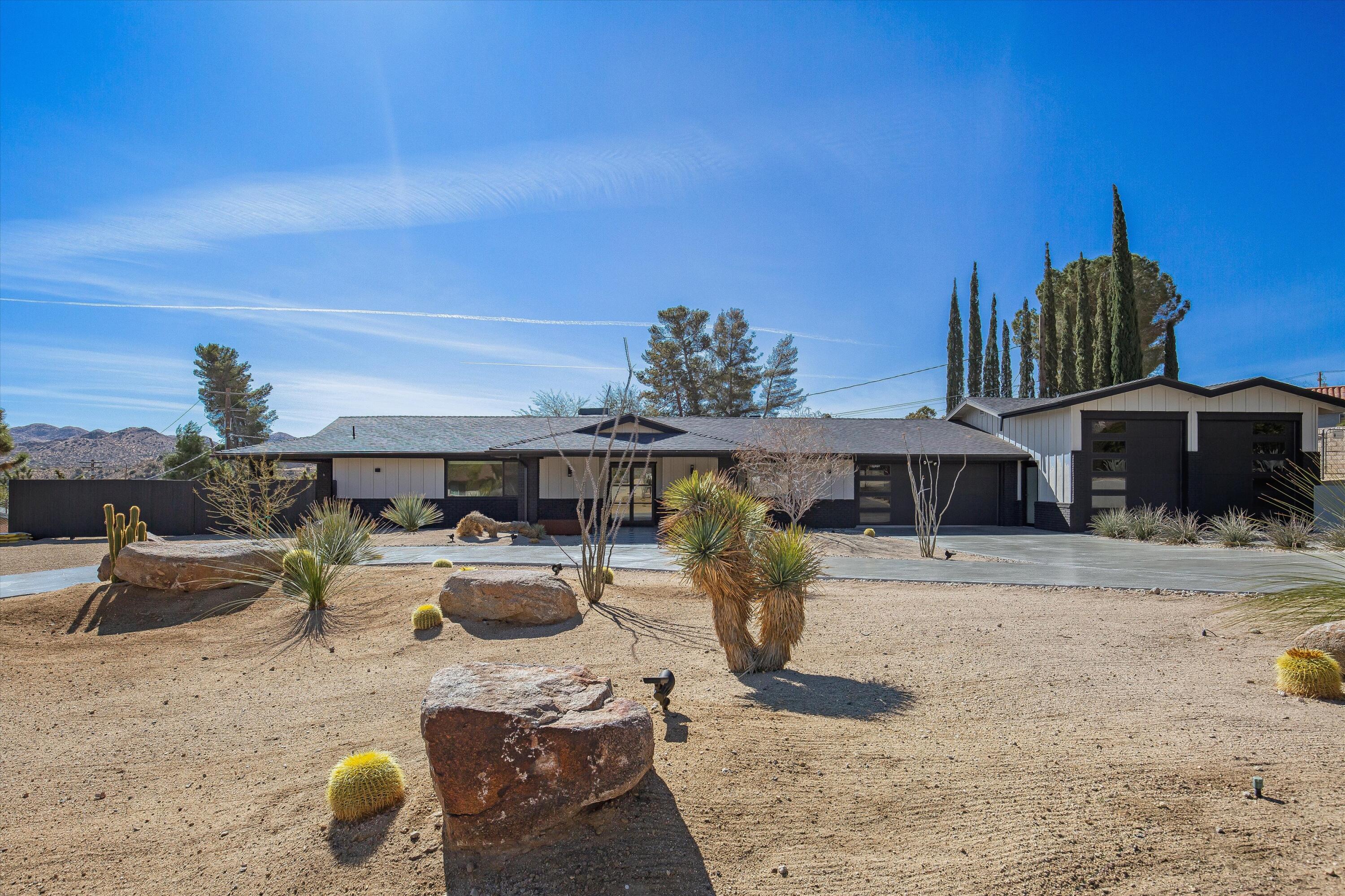 7458 Cardillo Trail Yucca Valley, CA 92284 - Photo 2 of 47 a view of a backyard with couches chair and potted plants