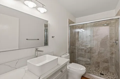 a bathroom with a sink toilet and shower