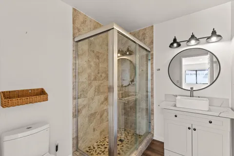 a bathroom with a sink a mirror and a shower