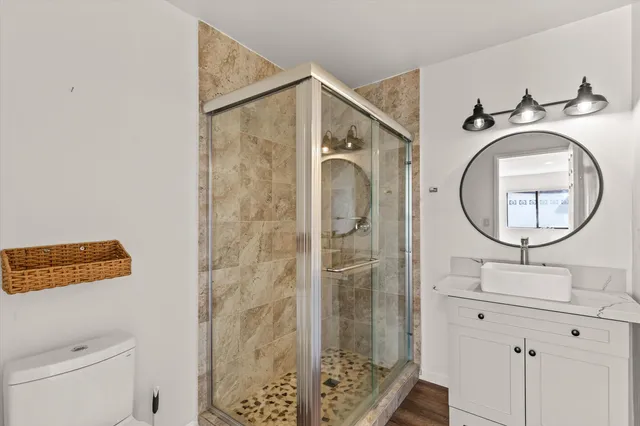 a bathroom with a sink a mirror and a shower