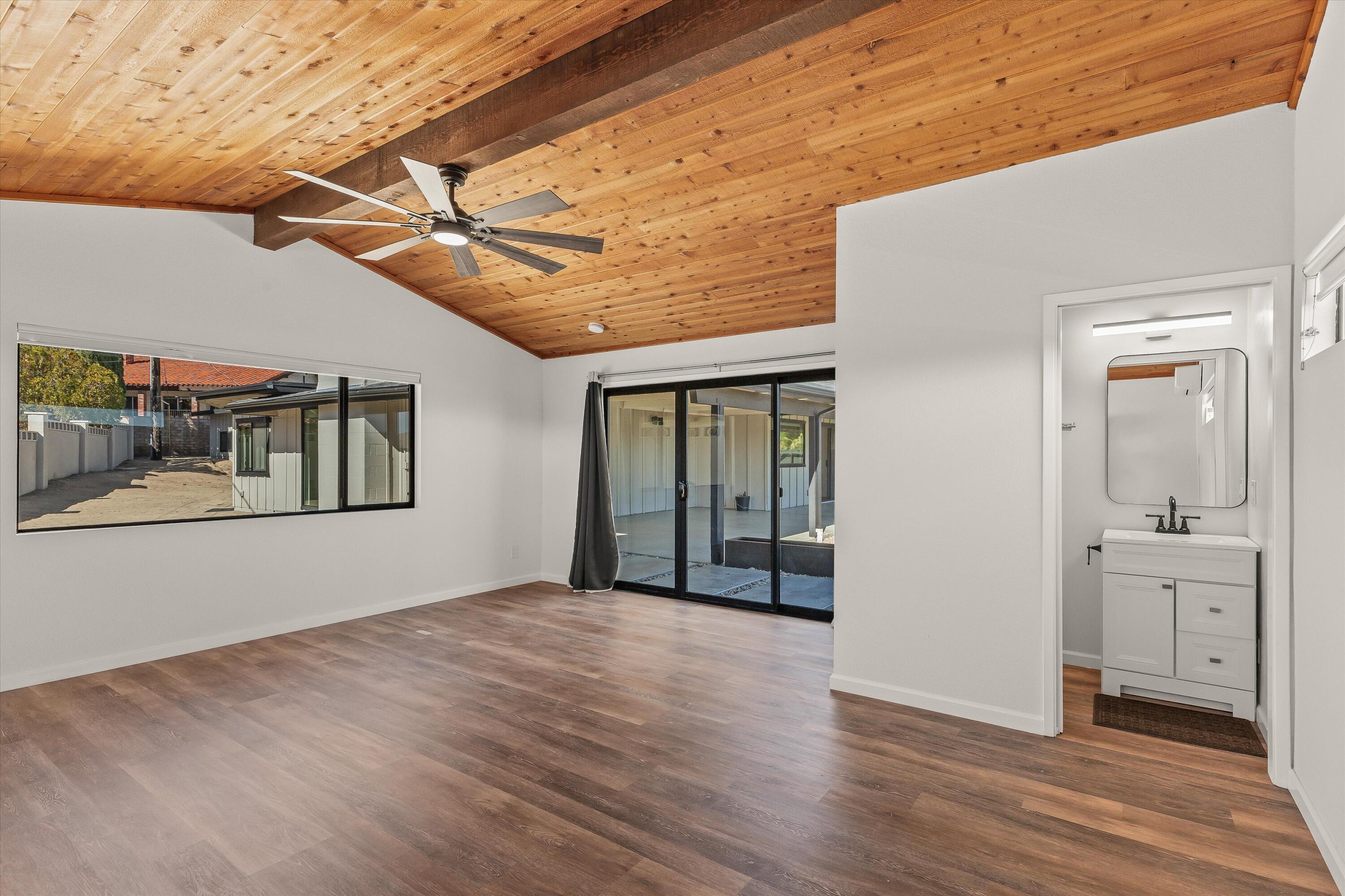 7458 Cardillo Trail Yucca Valley, CA 92284 - Photo 33 of 47 a view of an empty room with wooden floor and a window