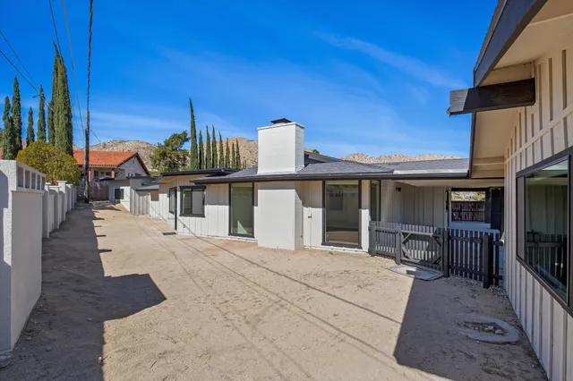 a view of a house with backyard porch and furniture